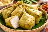 Ilustrasi ketupat. Resep Ketupat Simpel Masak Cuma 40 Menit, Hemat Gas dan Tetap Pulen.(Ilustrasi dibuat AI)