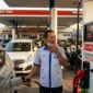 Petugas SPBU Sedang Melayani Konsumen.