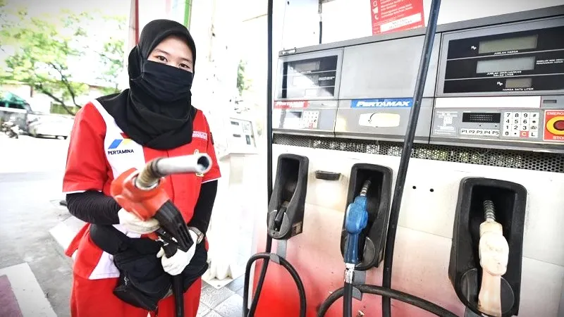 Petugas SPBu sedang melakukan pengisian BBM ke kendaraan.